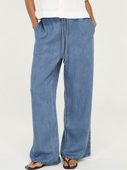 Image of a model wearing Pants. Product name - Staple The Label Talia Relaxed Pant in Chambray colour by brand - Staple