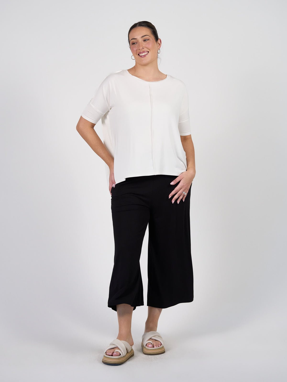 Image of a model wearing Tops. Product name - Stella Oversized Bamboo Slouch T-Shirt White in White colour by brand - Lou Lou