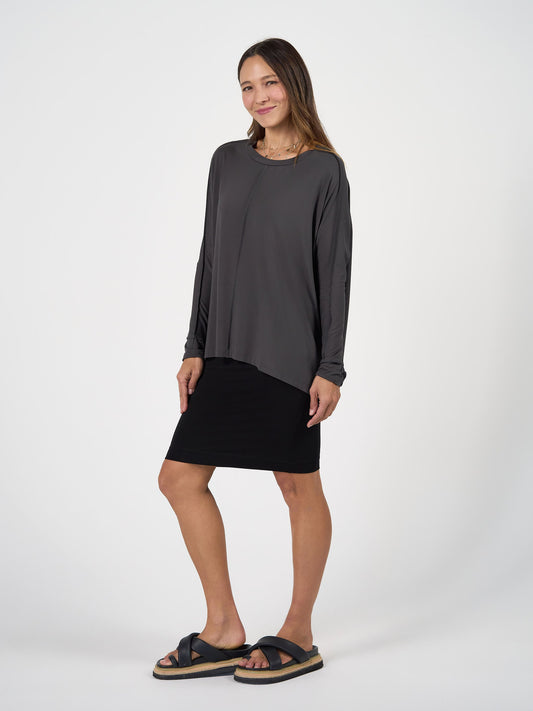 Image of a model wearing Tops. Product name - Stella Longsleeve Oversized Bamboo Slouch Top Steel in Steel colour by brand - Lou Lou
