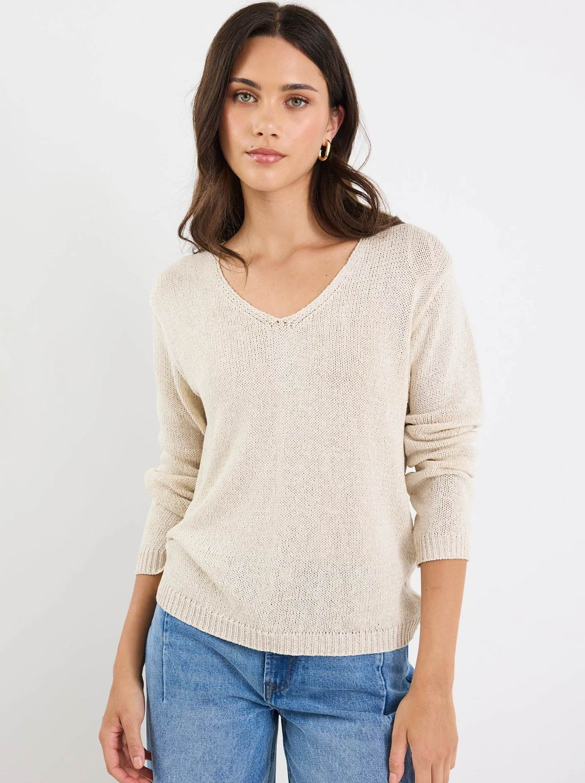 Image of a model wearing Outerwear. Product name - STORIES BE TOLD AFTERNOON RELAXED V NECK JUMPER in Natural colour by brand - Stories Be Told