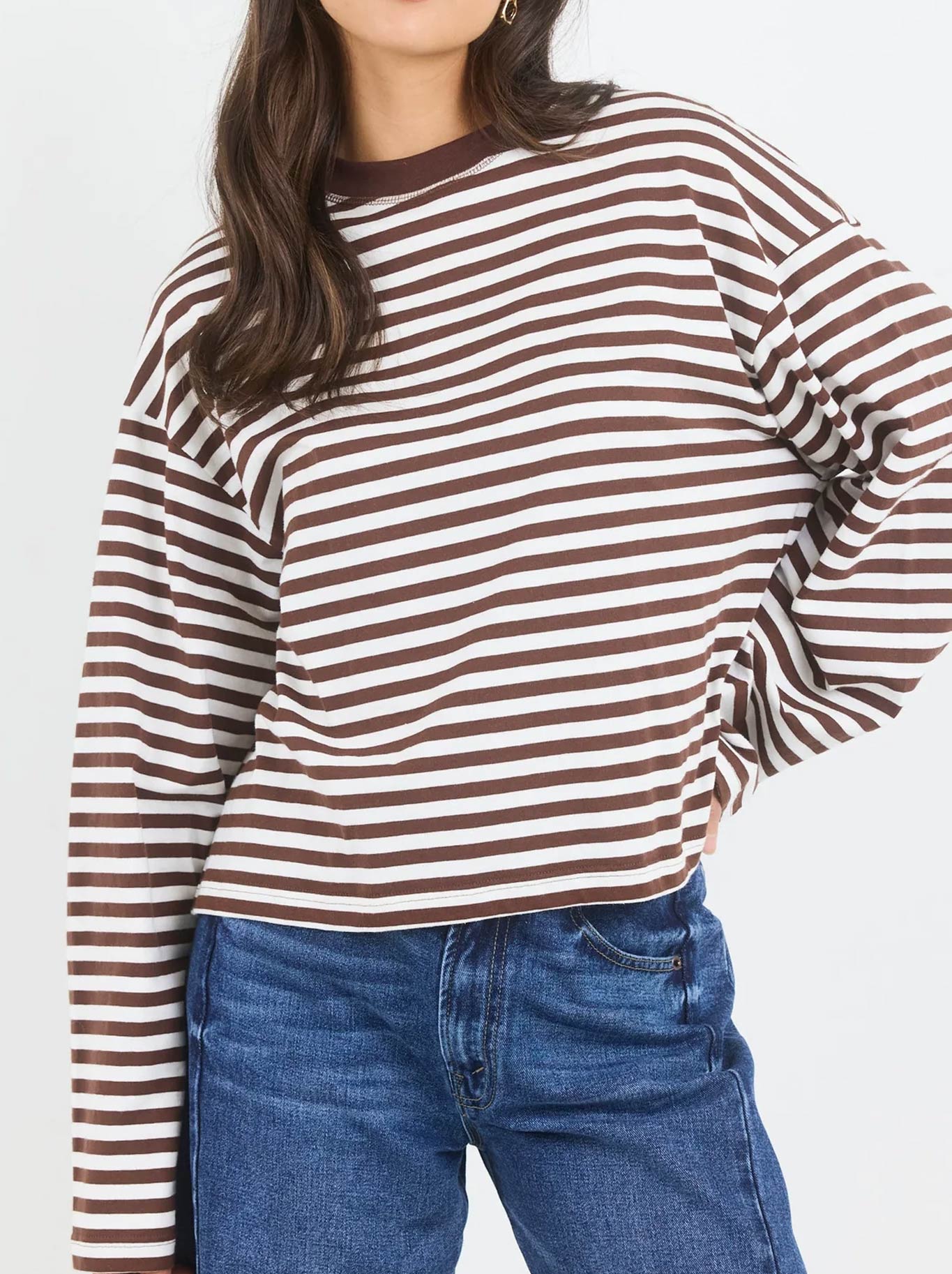 Image of a model wearing Tops. Product name - Stories Be Told Unite Stripe Long Sleeve Tee in Chocolate/White colour by brand - Stories Be Told