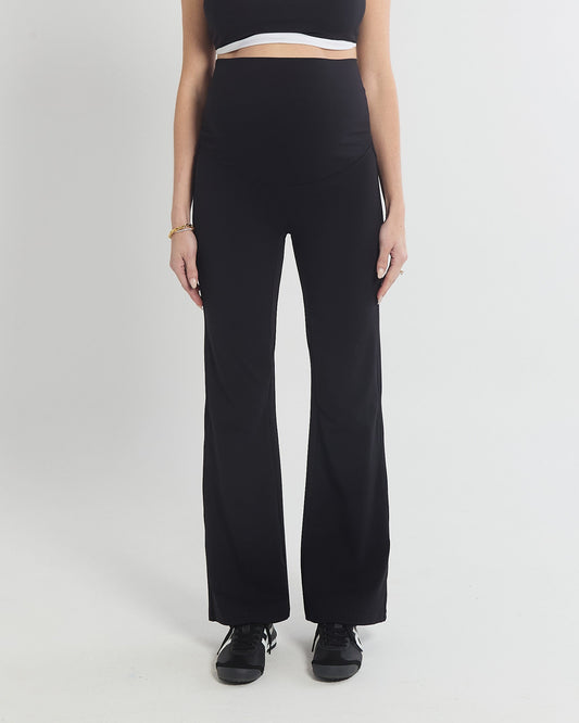 Image of a model wearing Pants. Product name - Straight Flare No Line Leggings in colour by brand - Soon Maternity