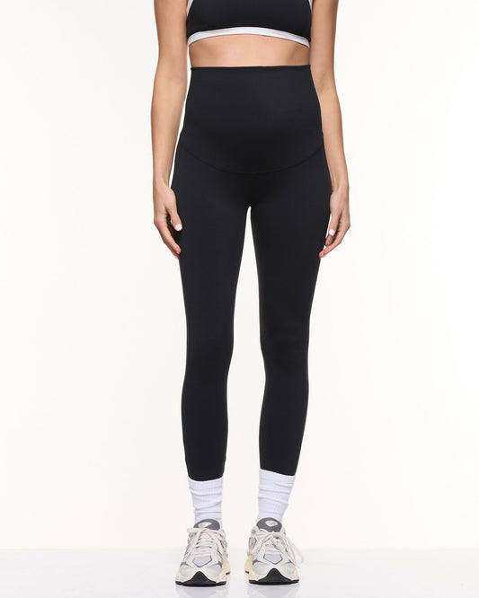 Image of a model wearing Pants. Product name - Super Stretch Foldover Leggings in Black colour by brand - Soon Maternity