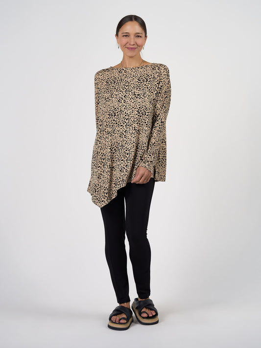 Image of a model wearing Tops. Product name - Susie Oversized Asymmetrical Bamboo Top Brown Leopard in Brown Leopard colour by brand - Lou Lou