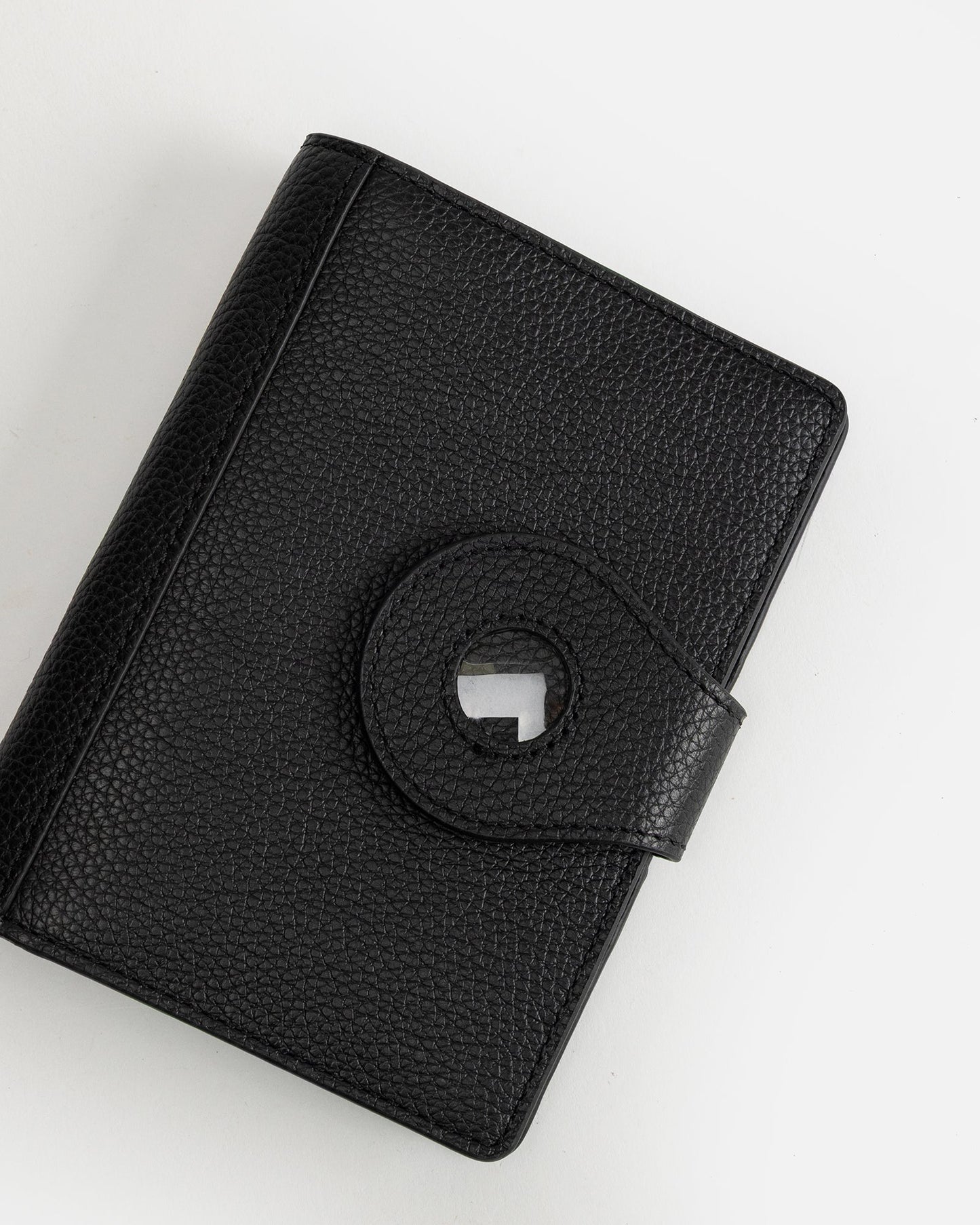 Image of Badge & Pass Holders. Productname: The Daily Edited Jude Airtag Passport Holder Black in Black colour by brand - The Daily Edited