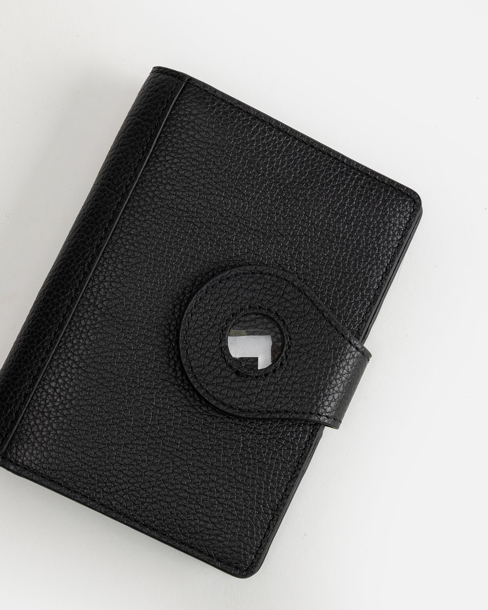 Image of Badge & Pass Holders. Productname: The Daily Edited Jude Airtag Passport Holder Black in Black colour by brand - The Daily Edited