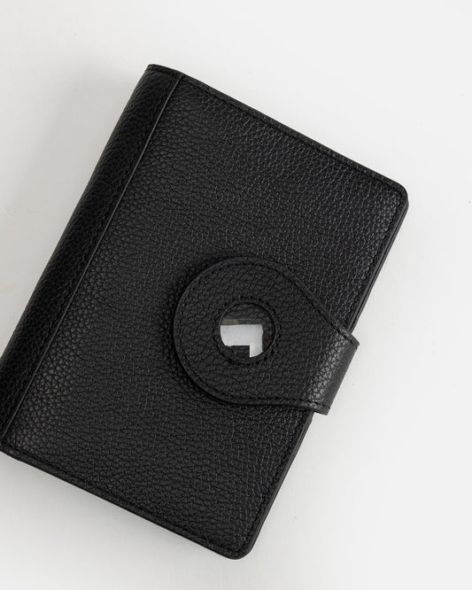 Image of Badge & Pass Holders. Productname: The Daily Edited Jude Airtag Passport Holder Black in Black colour by brand - The Daily Edited