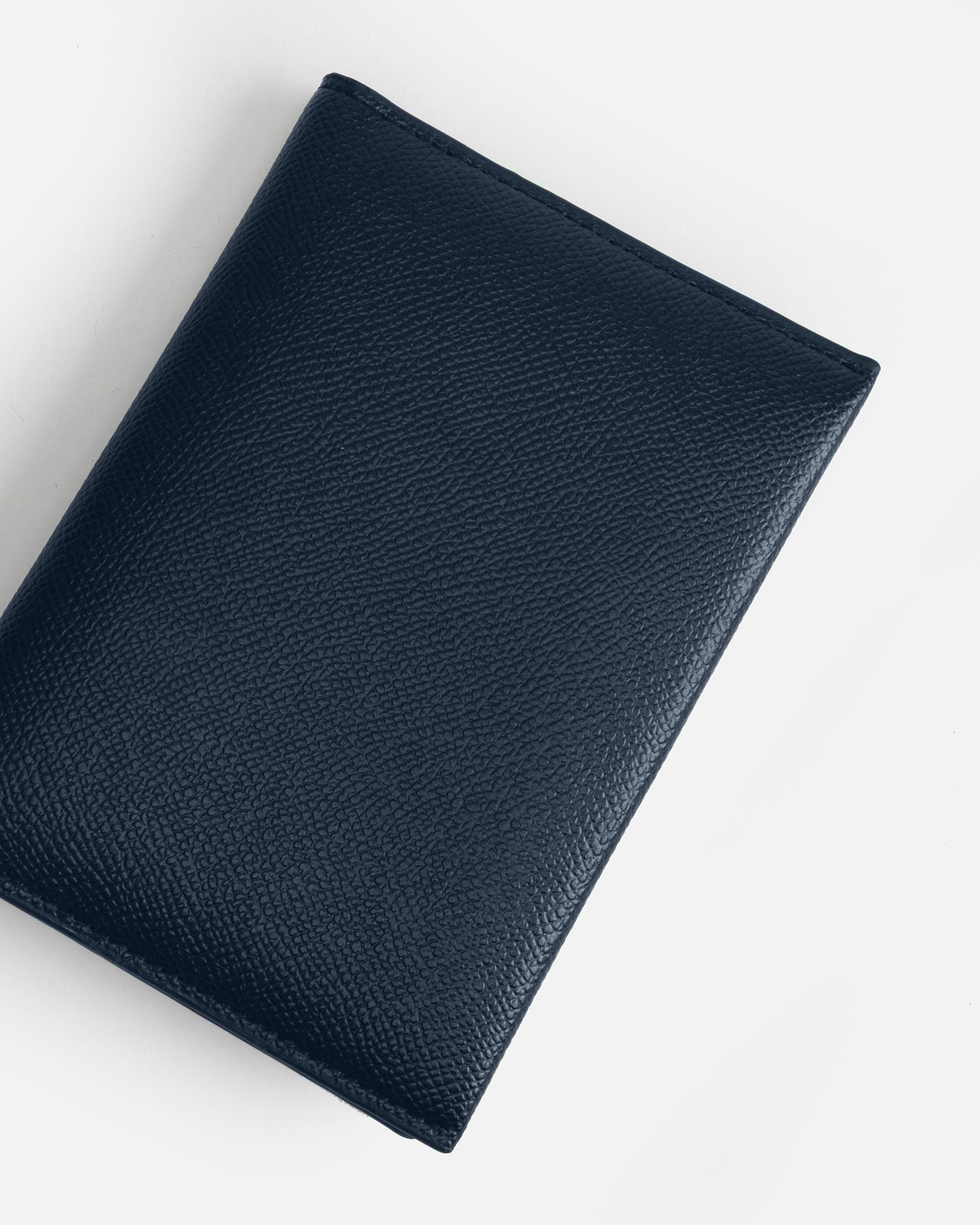 Image of Badge & Pass Holders. Product name - Essentials Passport Sleeve Navy in Navy colour by brand - The Daily Edited