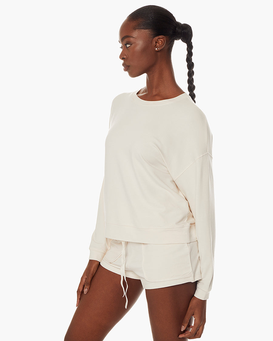 Image of a model wearing Tops. Productname: Coucher de Soleil Crew Cream in Cream colour by brand - TKEES