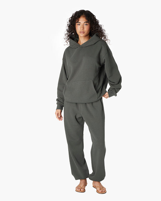 Image of a model wearing Outerwear. Productname: Air Whipped Hoodie Forest in Forest colour by brand - TKEES