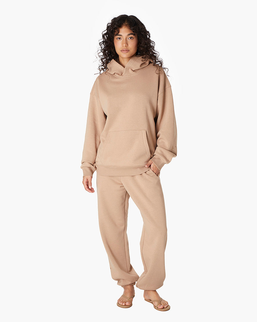Image of a model wearing Outerwear. Productname: Air Whipped Hoodie Camel in Camel colour by brand - TKEES