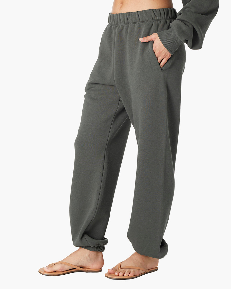 Image of a model wearing Pants. Productname: Air Whipped Sweatpant Forest in Forest colour by brand - TKEES