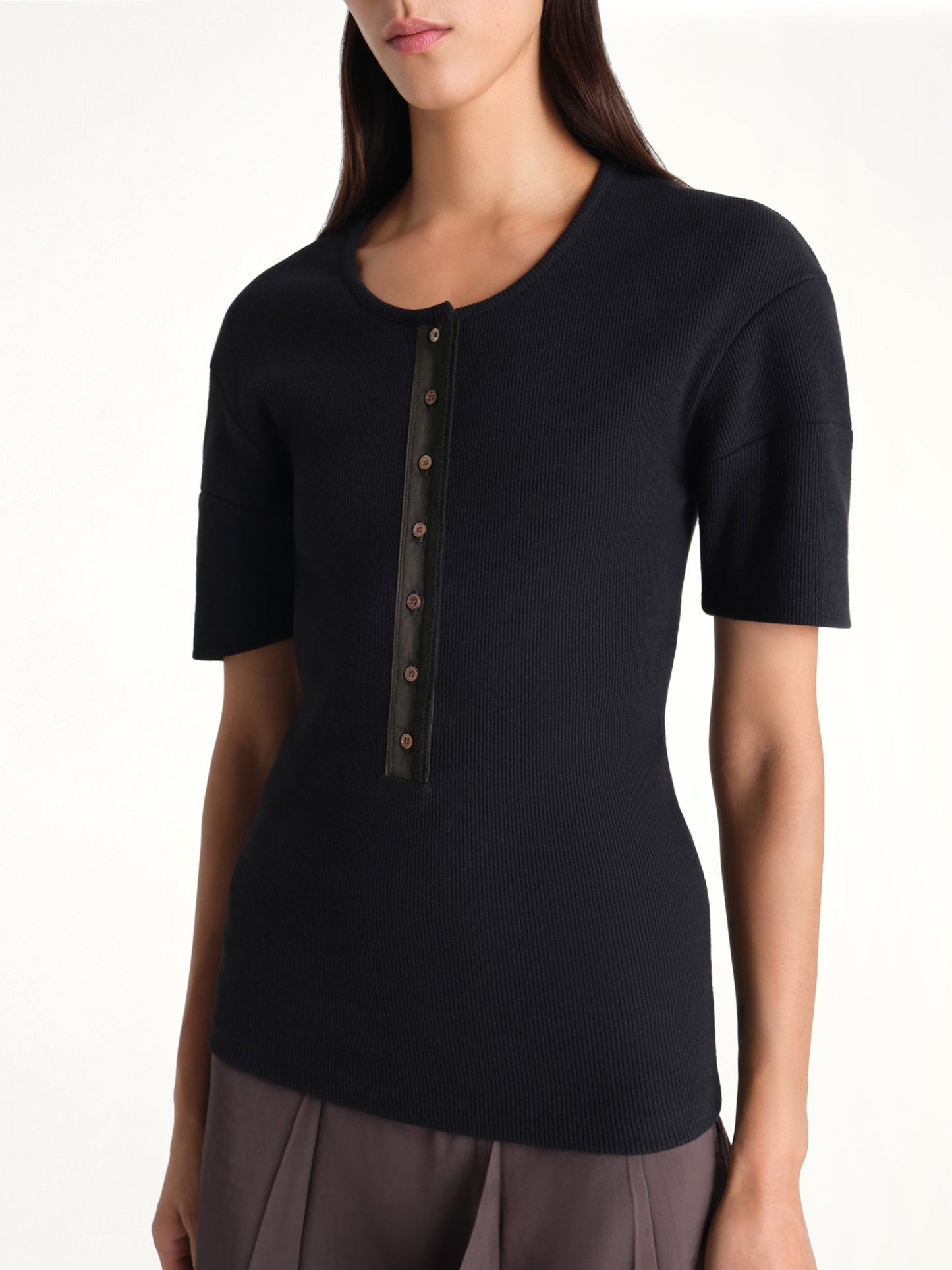 Image of a model wearing Tops. Product name - Fitted Henley in Black colour by brand - LEMAIRE