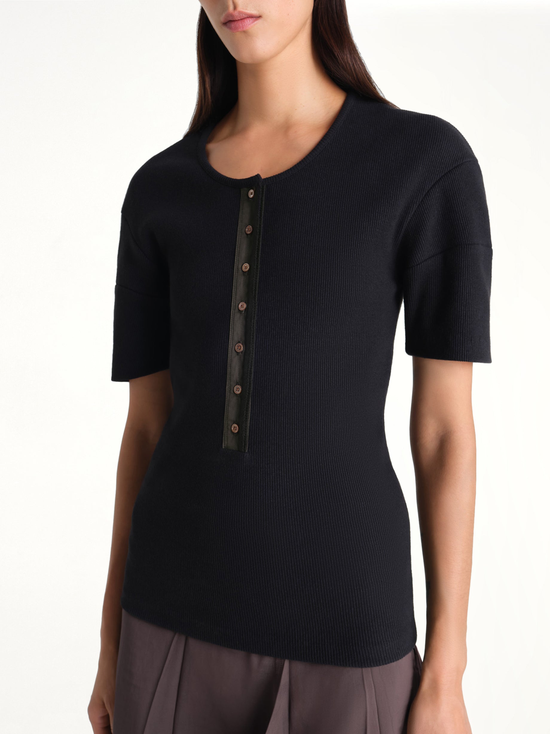 Image of a model wearing Tops. Product name - Fitted Henley in Black colour by brand - LEMAIRE