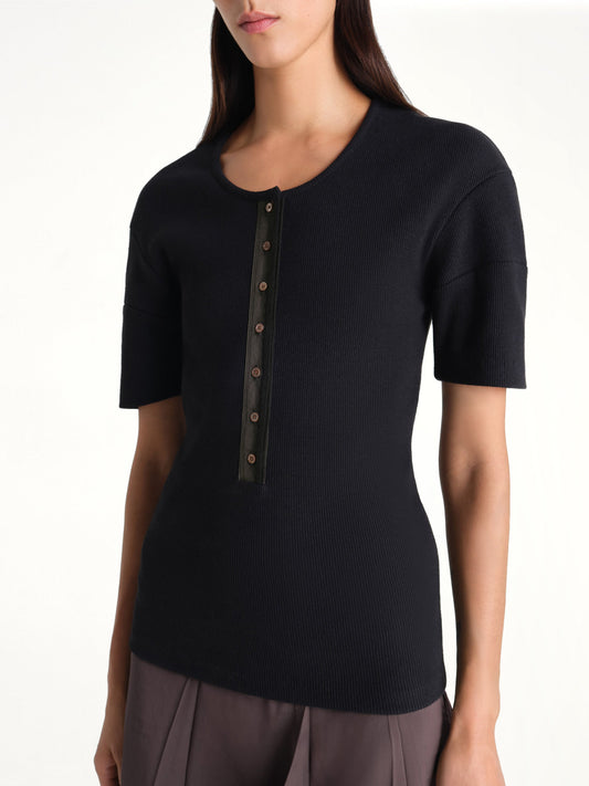 Image of a model wearing Tops. Product name - Fitted Henley in Black colour by brand - LEMAIRE