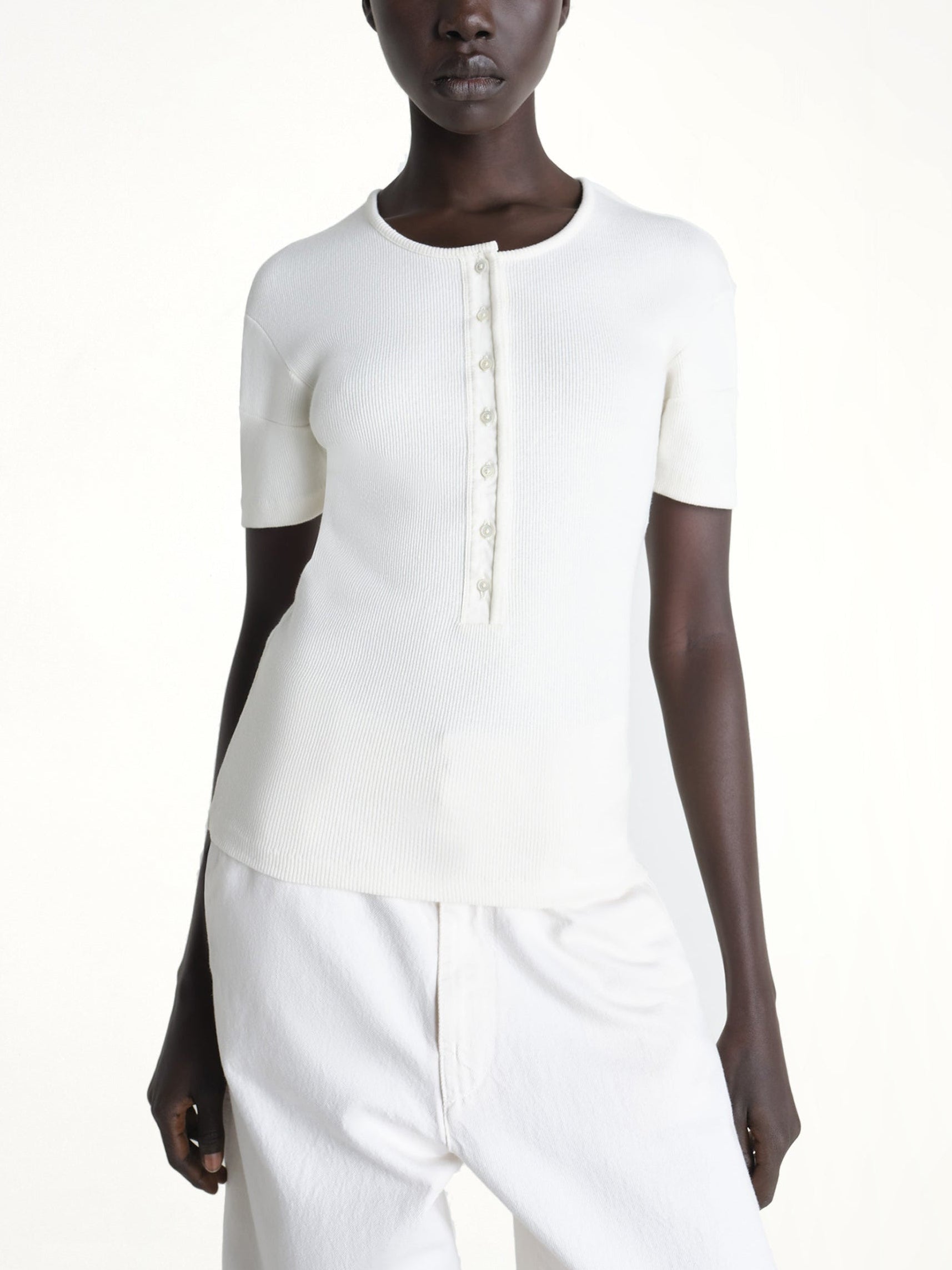 Image of a model wearing Tops. Product name - Fitted Henley in White colour by brand - LEMAIRE