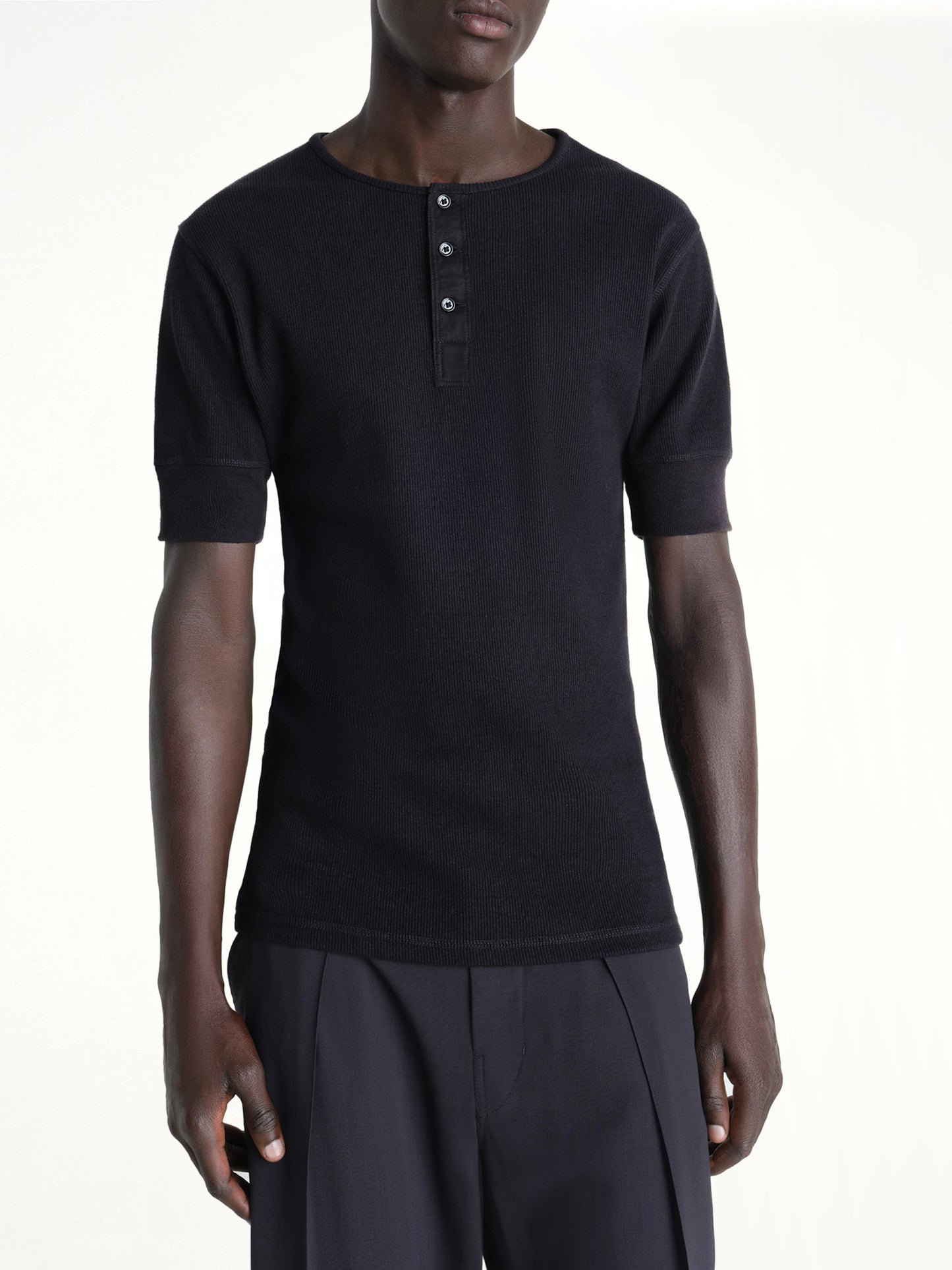 Image of a model wearing Tops. Product name - Rib Henley Top in Black colour by brand - LEMAIRE