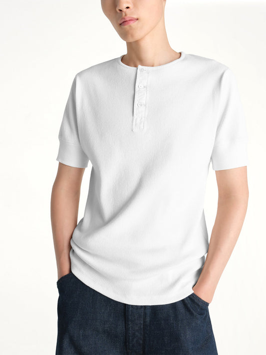 Image of a model wearing Tops. Product name - Rib Henley Top in White colour by brand - LEMAIRE