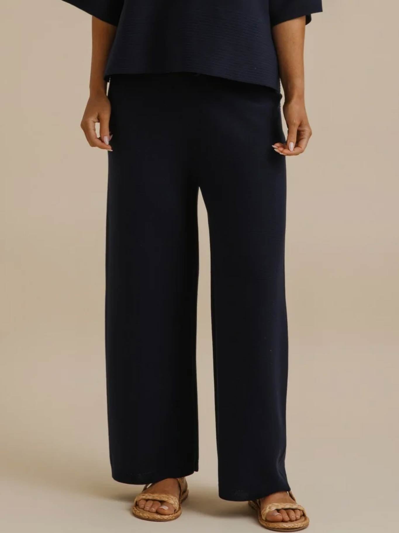 Image of a model wearing Pants. Product name - Talamaya Grace Summer Pant in Pool colour by brand - Talamaya