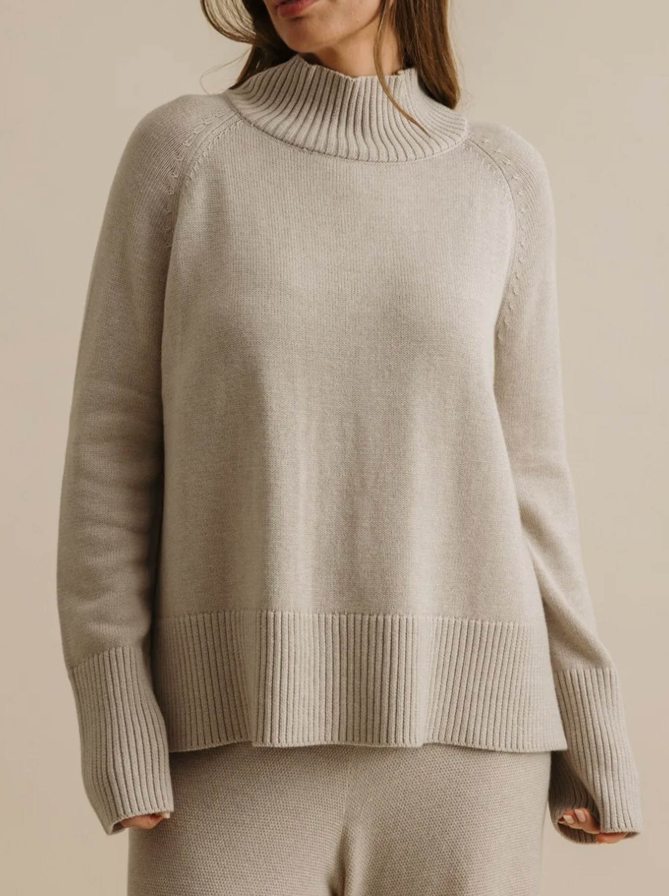 Image of a model wearing Outerwear. Productname: Talamaya Harmony Mock Neck Pullover in Wheat colour by brand - Talamaya