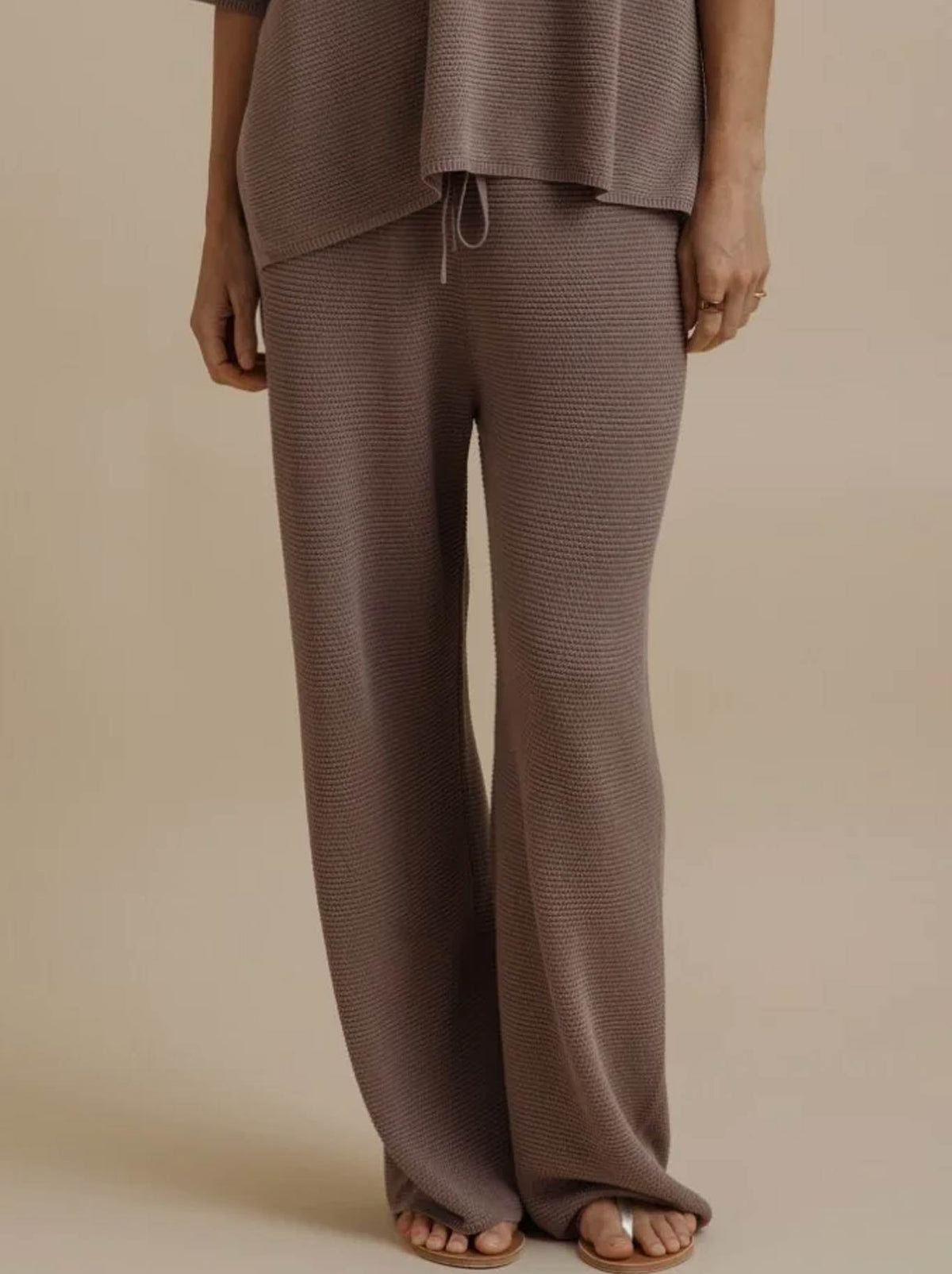 Image of a model wearing Pants. Product name - TALAMAYA LATTICE CRUISE PANT in Husk colour by brand - Talamaya