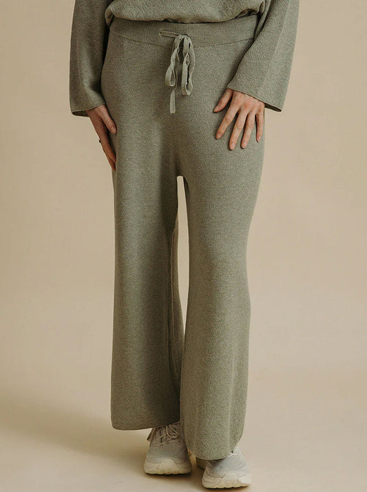Image of a model wearing Pants. Productname: TALAMAYA WINTER RETREAT MERINO COTTON PANT in Acacia colour by brand - Talamaya