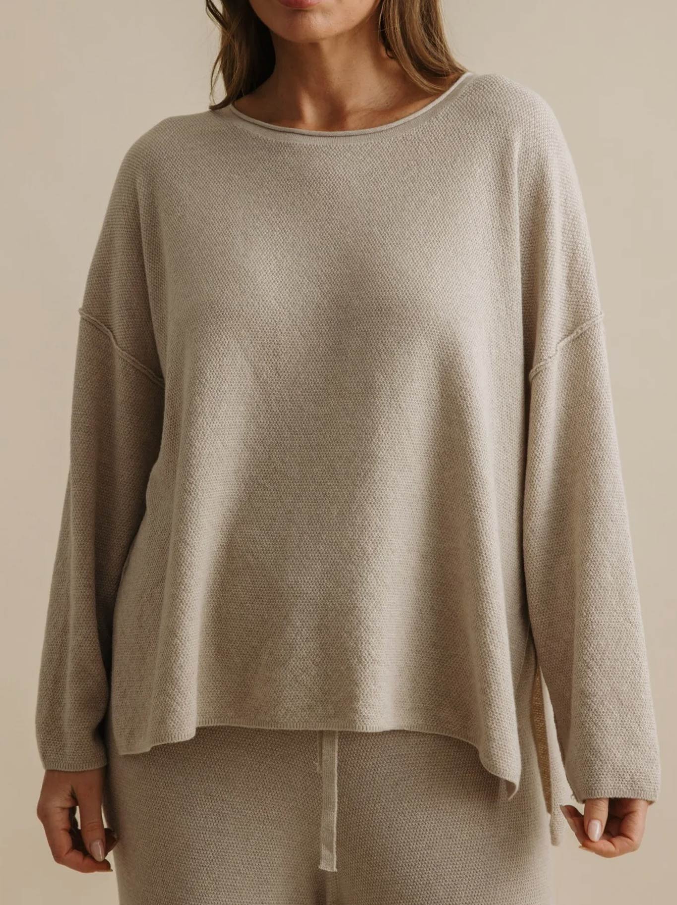 Image of a model wearing Tops. Product name - TALAMAYA WINTER RETREAT PULLOVER in Wheat colour by brand - Talamaya