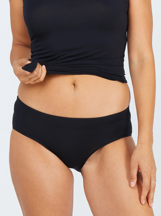 Image of a model wearing Pants. Productname: TANI HIPSTER BIKINI in Black colour by brand - Tani