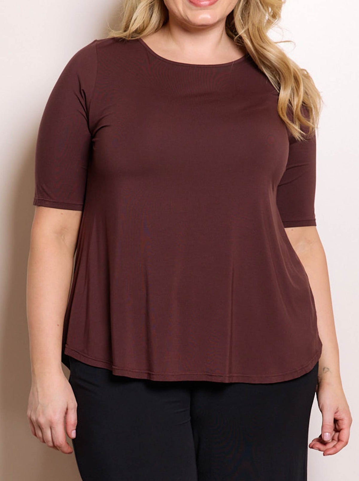 Image of a model wearing Tops. Product name - TANI ELBOW SWING TEE in Merlot colour by brand - Tani
