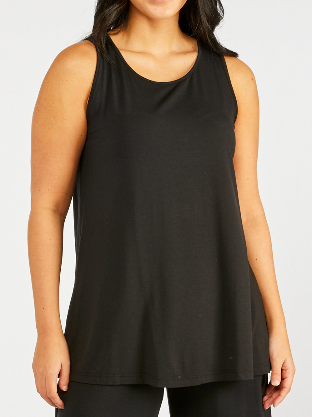 Image of a model wearing Tops. Productname: TANI GRACE SWING TANK in Black colour by brand - Tani