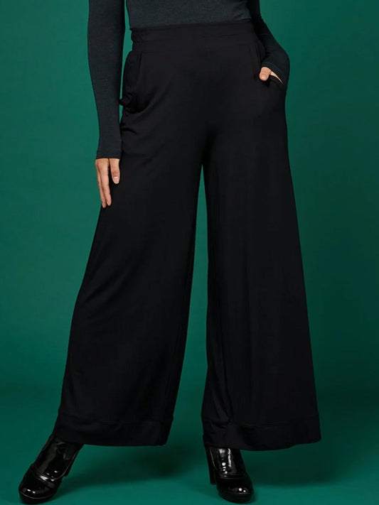 Image of a model wearing Pants. Productname: Tani Bella Palazzo Pant in Black colour by brand - Tani