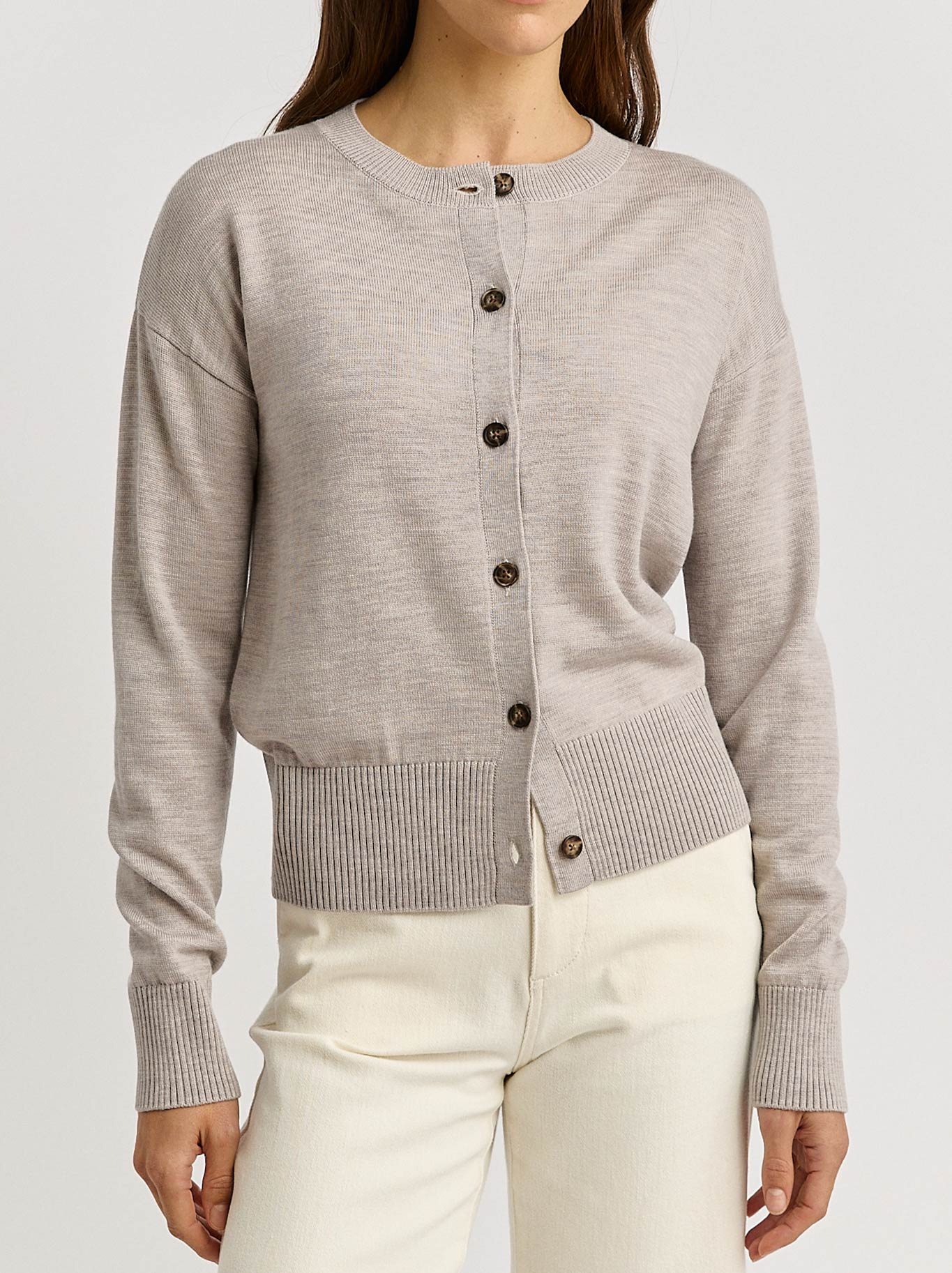 Image of a model wearing Outerwear. Productname: TOORALLIE FINE KNIT CARDI in Light Oat colour by brand - Toorallie