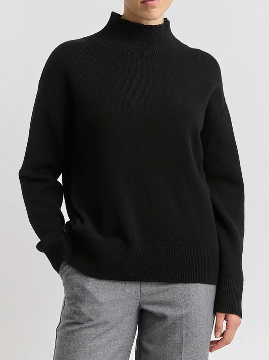 Image of a model wearing Tops. Product name - TOORALLIE SPLIT NECK FUNNEL in Black colour by brand - Toorallie