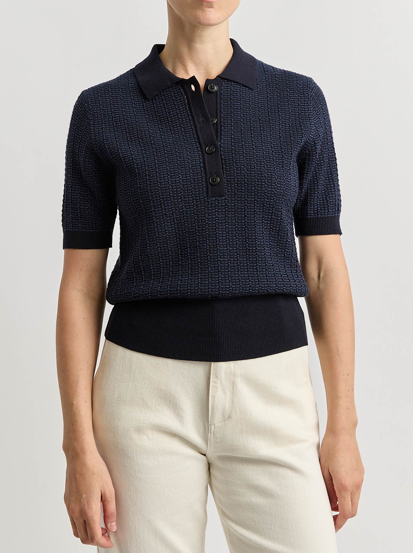 Image of a model wearing Tops. Product name - Toorallie Knit Polo in French Navy colour by brand - Toorallie
