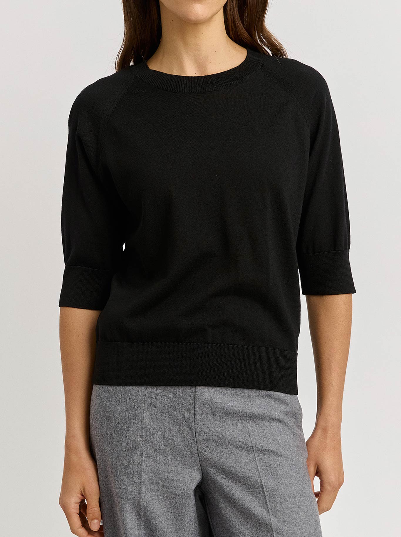 Image of a model wearing Tops. Product name - Toorallie Extra Fine Raglan Sleeve Top in Black colour by brand - Toorallie