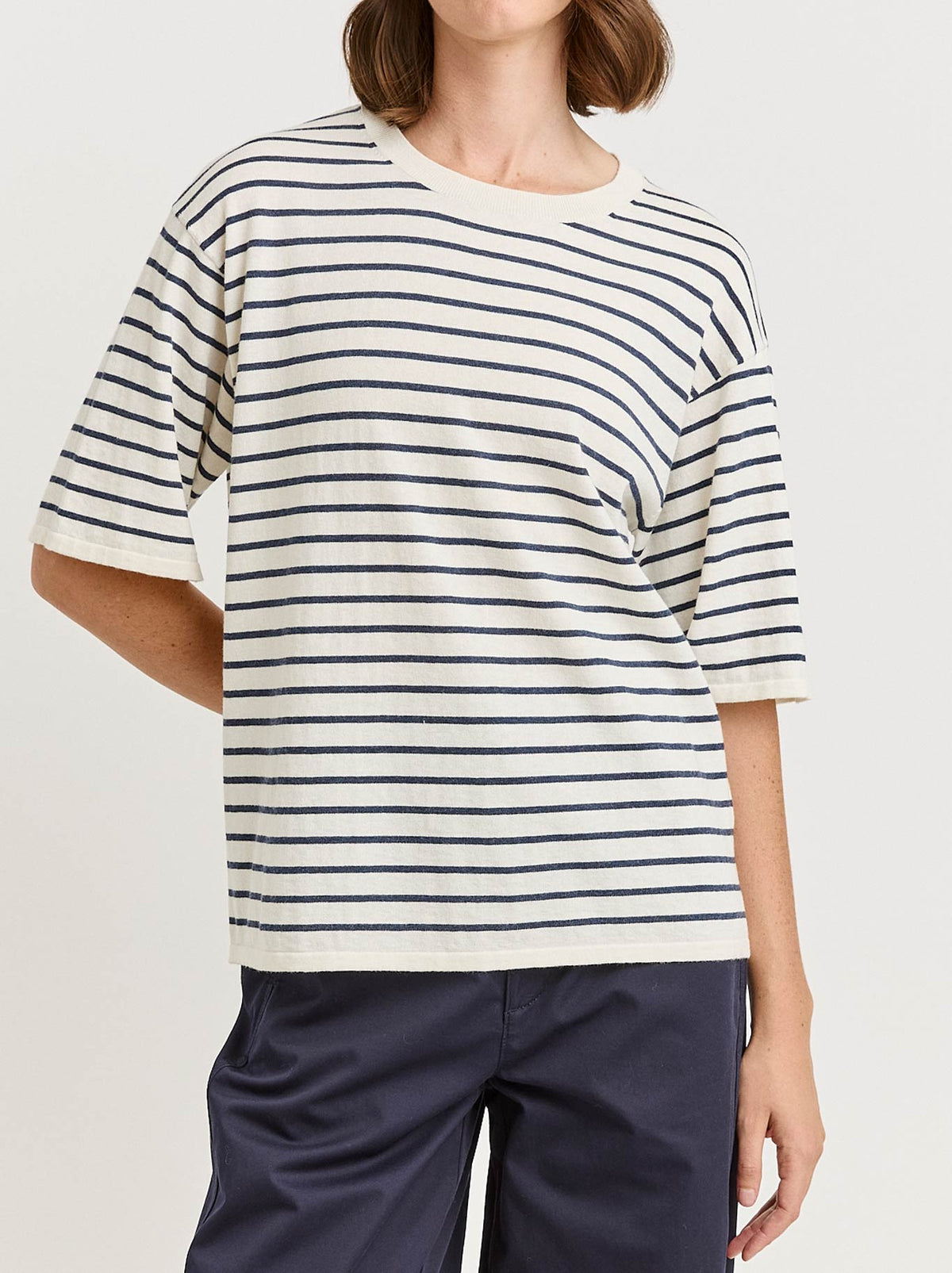 Image of a model wearing Tops. Product name - Toorallie Relaxed Stripe Knit Tee in White colour by brand - Toorallie