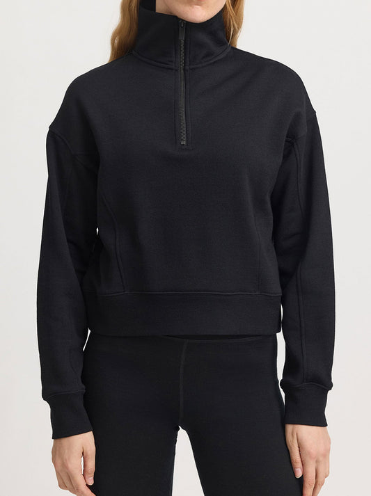 Image of a model wearing Tops. Product name - Toorallie Lounge Cropped Half Zip in Black colour by brand - Toorallie