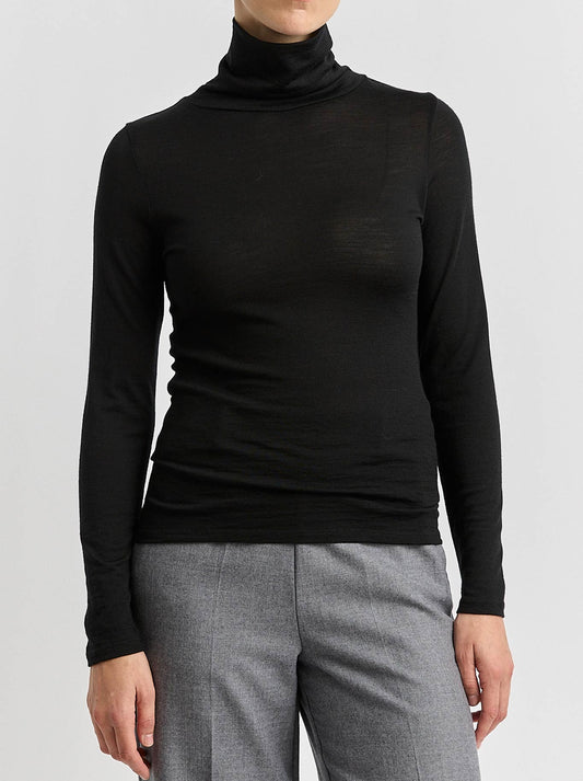 Image of a model wearing Tops. Product name - TOORALLIE MERINO TURTLE NECK in Black colour by brand - Toorallie