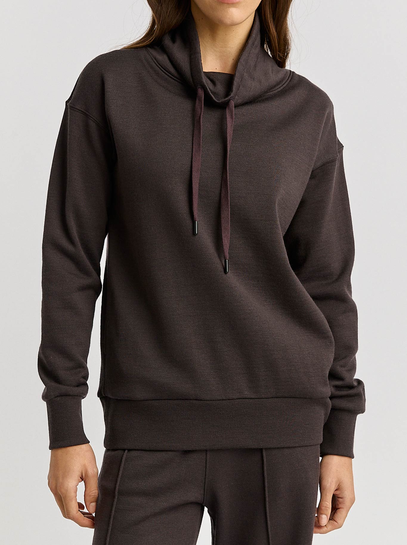Image of a model wearing Outerwear. Productname: TOORALLIE LOUNGE FUNNEL NECK in Date colour by brand - Toorallie