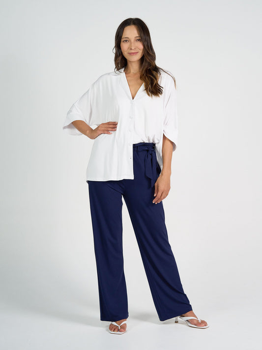 Image of a model wearing Pants. Product name - Tyler Bamboo Paperbag Pant Navy in Navy colour by brand - Lou Lou