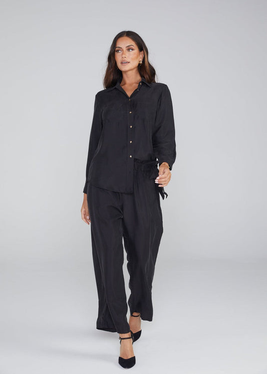 Image of a model wearing Tops. Product name - The Silk Long-sleeve Shirt in Black colour by brand - Lou Lou