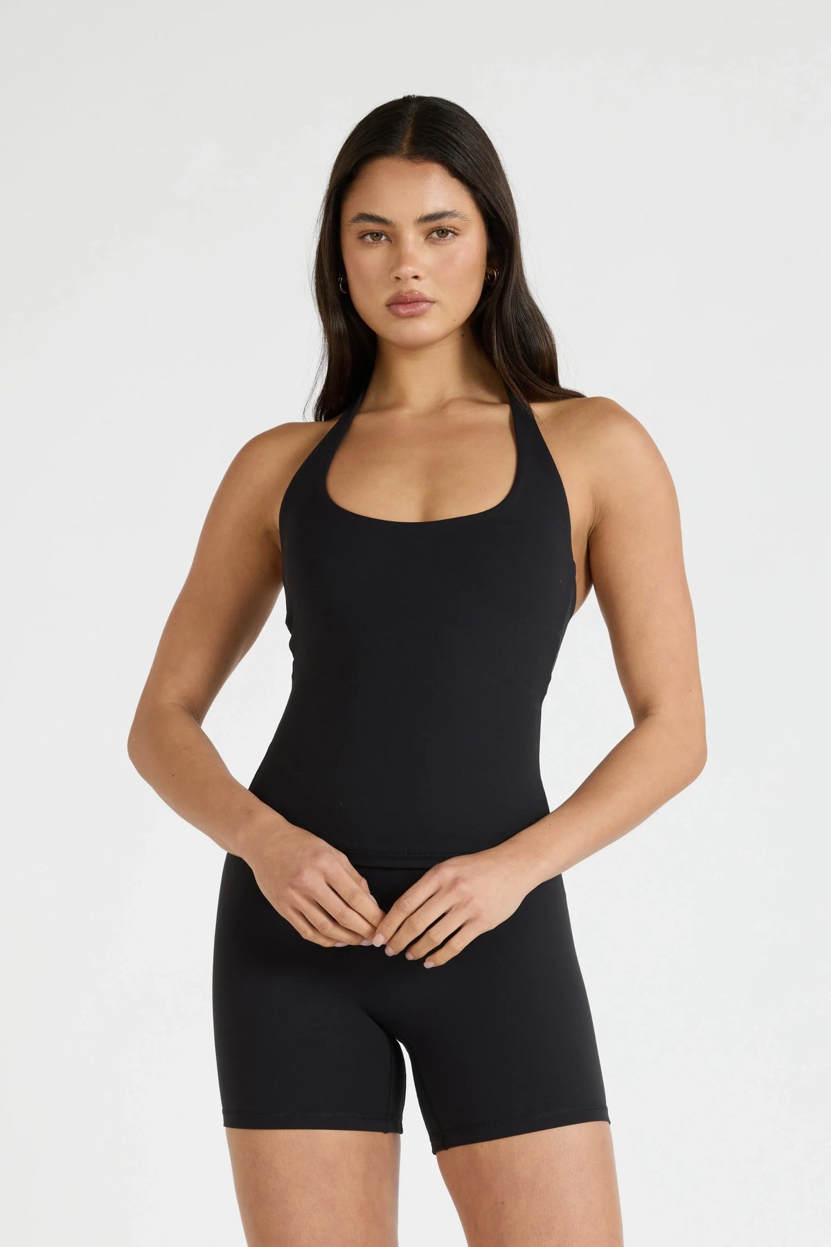 Image of a model wearing Tops. Product name - ALLFENIX CloudCore Halter Tank in Tan colour by brand - All Fenix