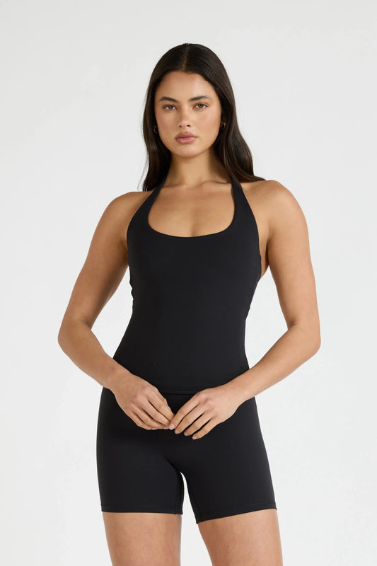 Image of a model wearing Tops. Product name - ALLFENIX CloudCore Halter Tank in Tan colour by brand - All Fenix
