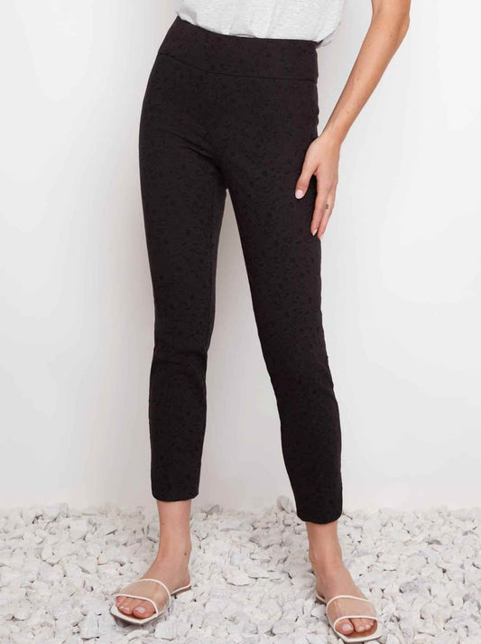 Image of a model wearing Pants. Product name - Up! Techno Jacquard Slim Leg Petal Pant in Black Loom colour by brand - Up Pants