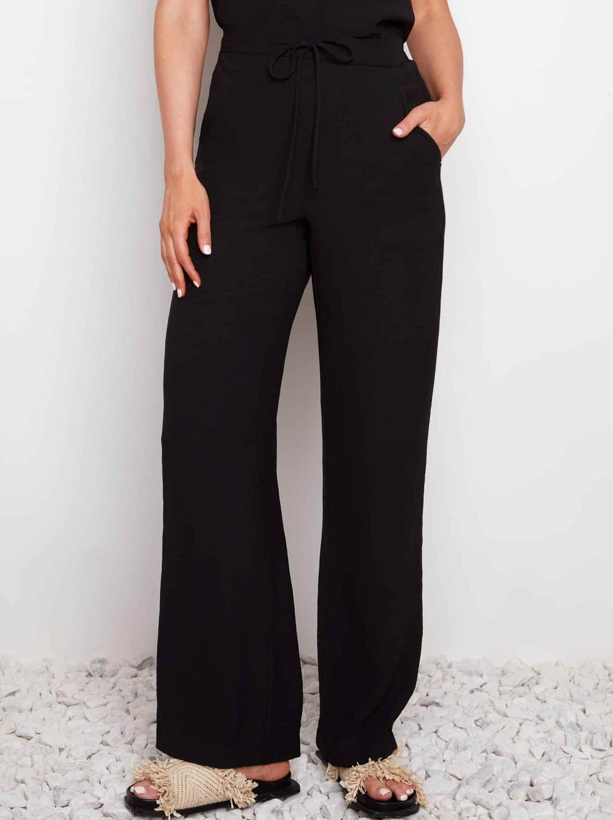 Image of a model wearing Pants. Product name - UP! AIR FLOW WIDE LEG PANT in Black colour by brand - Up Pants