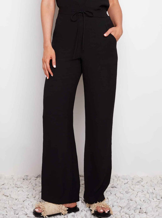 Image of a model wearing Pants. Product name - UP! AIR FLOW WIDE LEG PANT in Black colour by brand - Up Pants