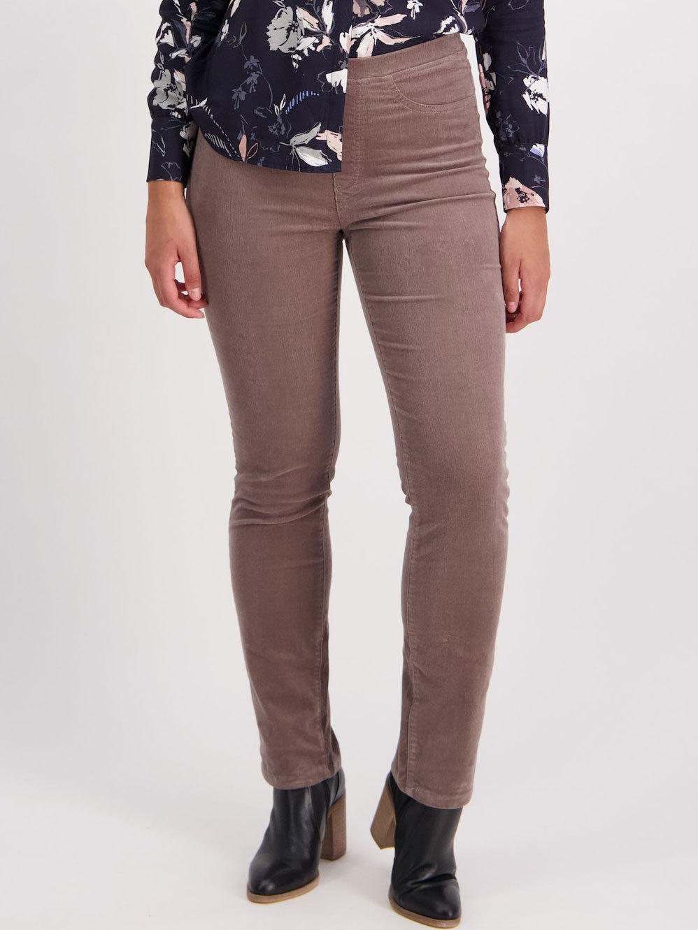 Image of a model wearing Pants. Product name - Vassalli Bay Slim Leg Cord Pull On Pant in Taupe colour by brand - Vassalli