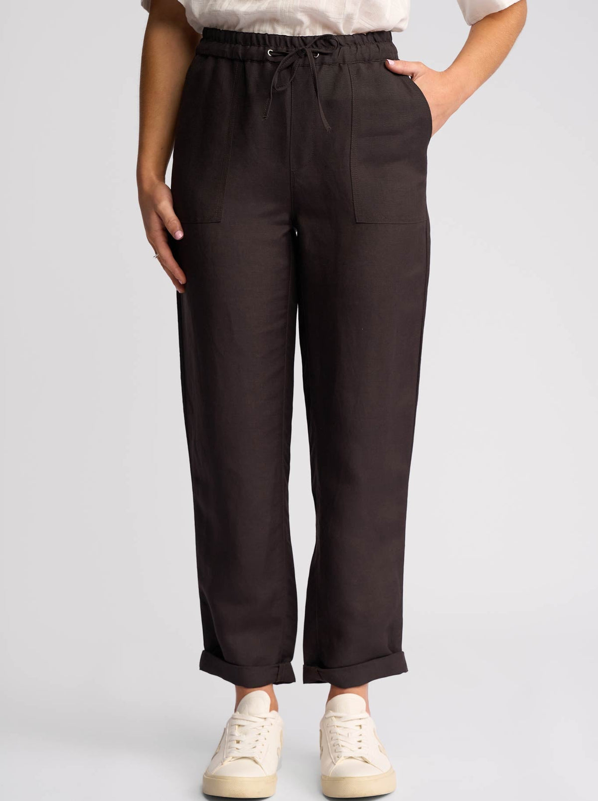 Image of a model wearing Pants. Product name - Vassalli Oxford Slim Leg Ankle Grazer in Chocolate colour by brand - Vassalli