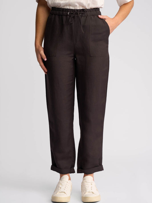 Image of a model wearing Pants. Product name - Vassalli Oxford Slim Leg Ankle Grazer in Chocolate colour by brand - Vassalli