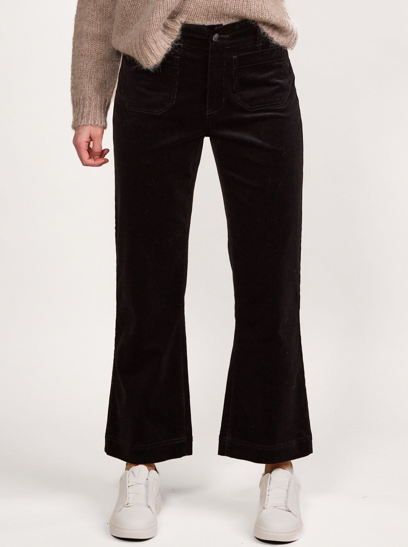 Image of a model wearing Pants. Product name - VASSALLI ANKLE GRAZER CORD PANT in Black colour by brand - Vassalli